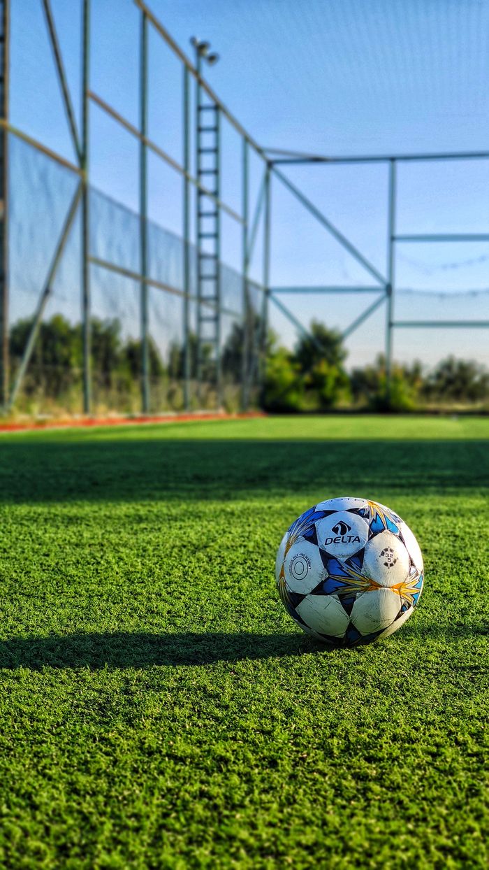 our-story-01 Vibrant photo of a soccer ball on an outdoor field in Istanbul, Turkey.